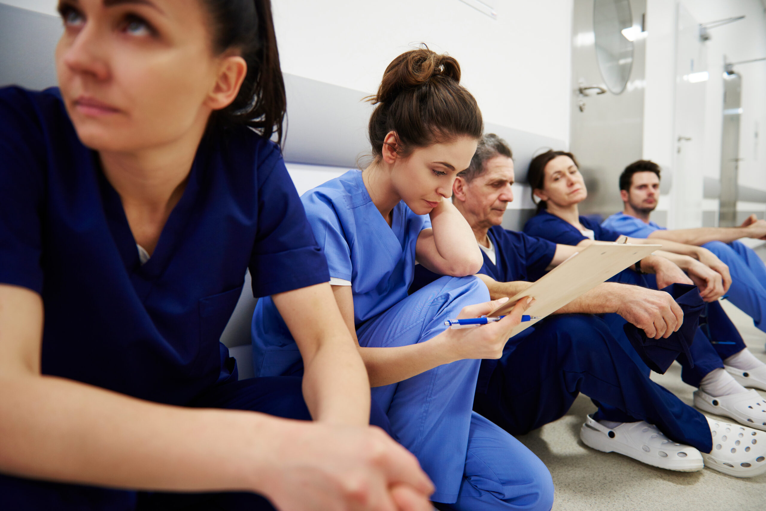 Female nurse examining medical records in the corridor